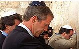 Bush prays at wall wearing yamaka