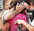 Joseph Randazzo hugs a family member outside his dad's home in Hillcrest, Queens, yesterday. Carmine Randazzo was fatally stabbed while strolling in the neighborhood.