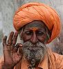 Orange-colored turban wearing 'South Asian'